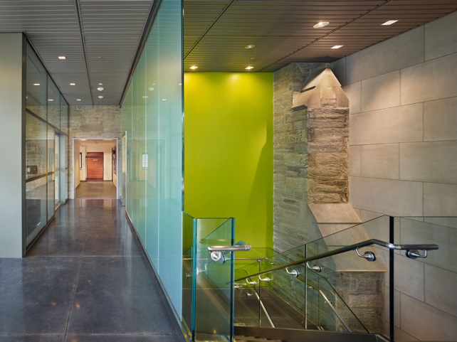 New materials meets existing stone in hallway corridor and staircase.