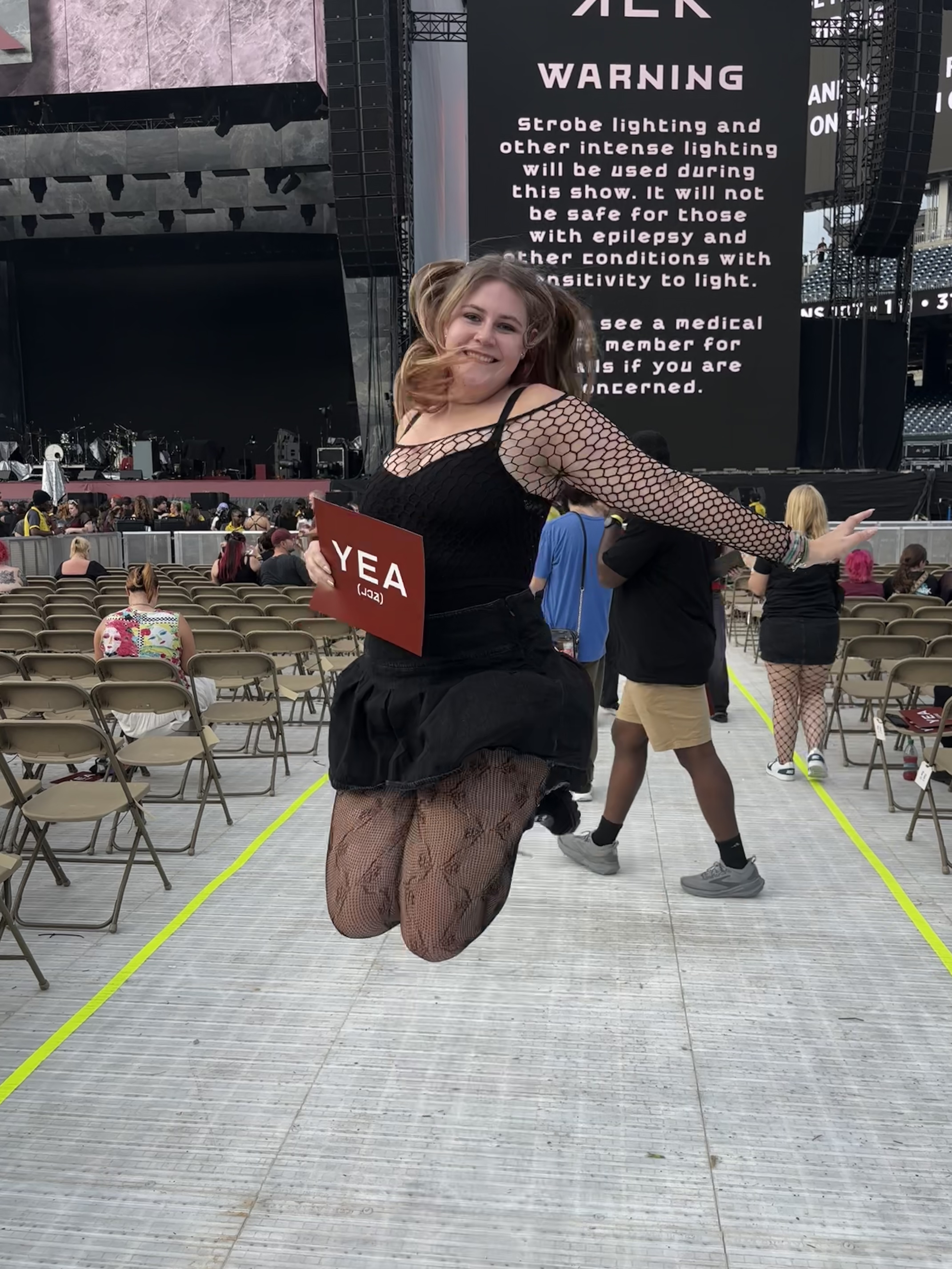 A girl jumping at a concert