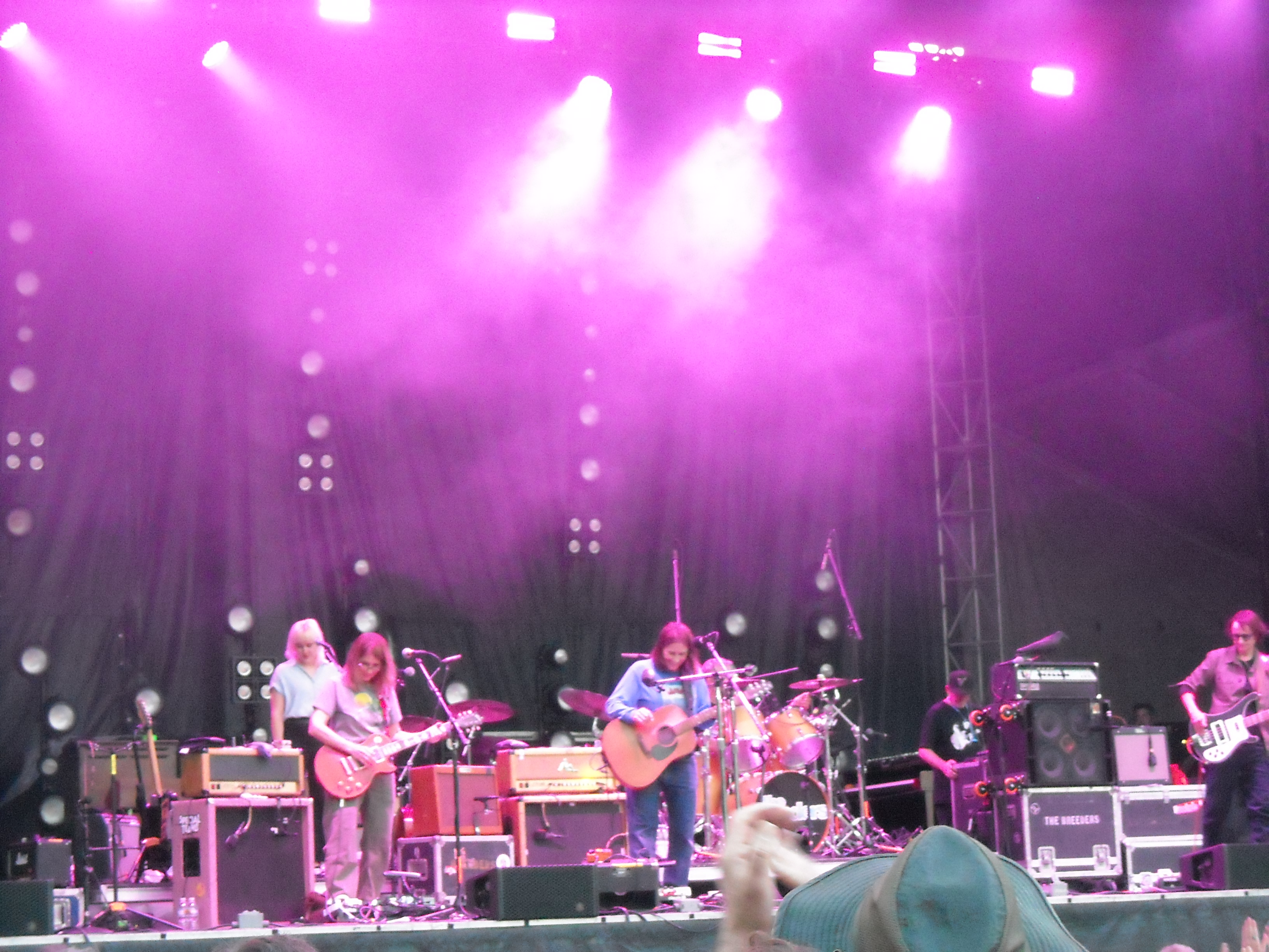 The band The Breeders playing on stage with purple lighting