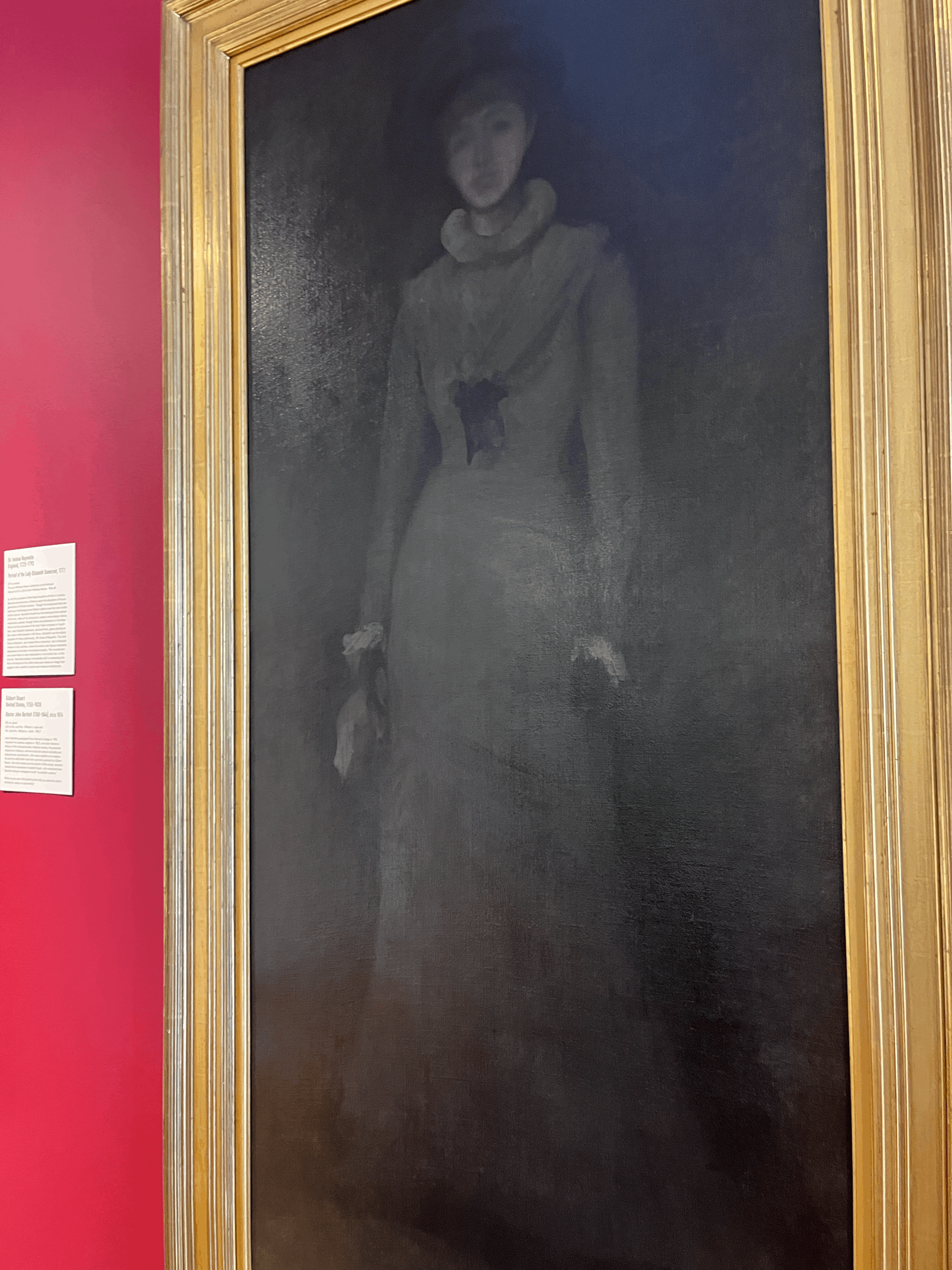A framed painting of women, she is painted in grey and background is black.